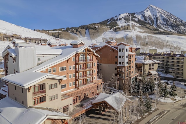 snowy aerial view with a mountain view