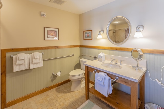 bathroom with wood walls, sink, and toilet