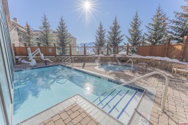 view of pool featuring a mountain view and a patio