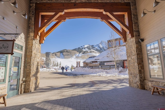 snow covered patio featuring a mountain view