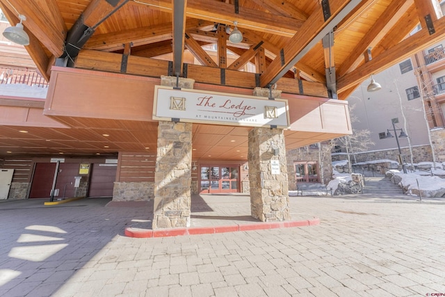 exterior space with beam ceiling, wooden ceiling, and high vaulted ceiling