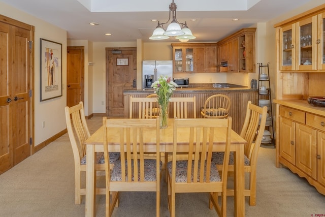 carpeted dining area featuring a skylight