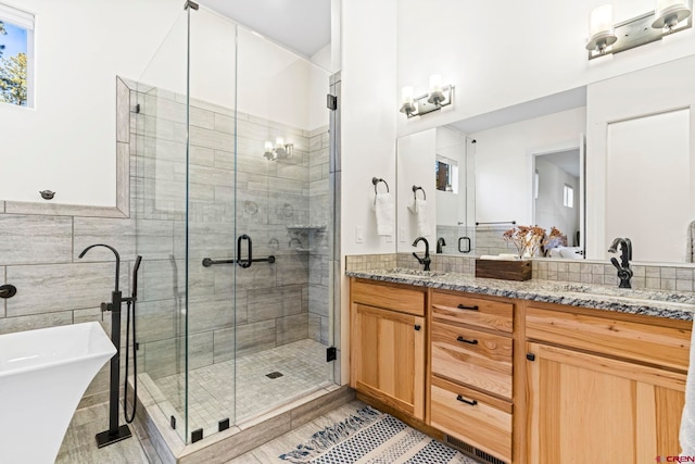 bathroom with vanity, independent shower and bath, and tile walls