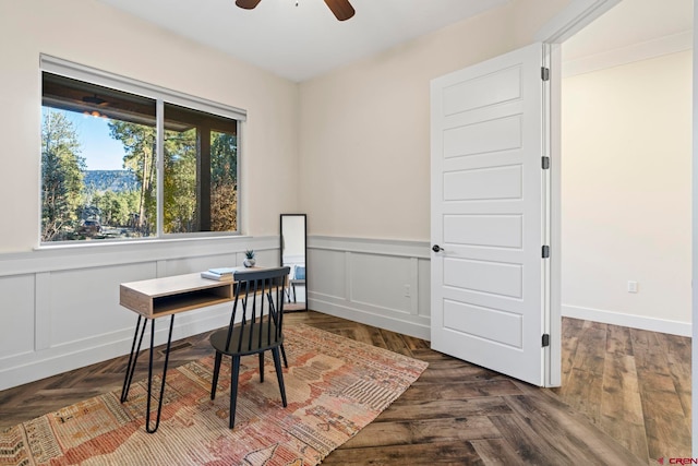 home office with dark parquet flooring and ceiling fan