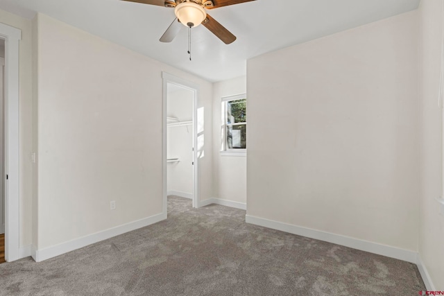 carpeted empty room featuring ceiling fan