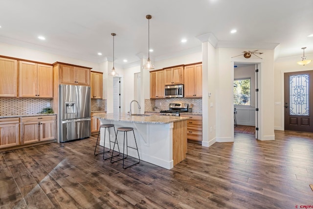 kitchen with sink, stainless steel appliances, dark hardwood / wood-style floors, backsplash, and a kitchen island with sink