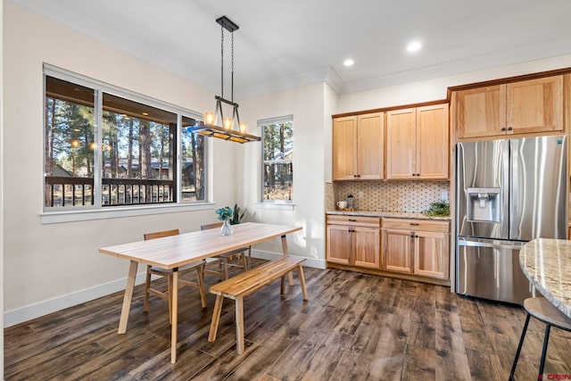 dining room featuring dark hardwood / wood-style flooring, plenty of natural light, and ornamental molding