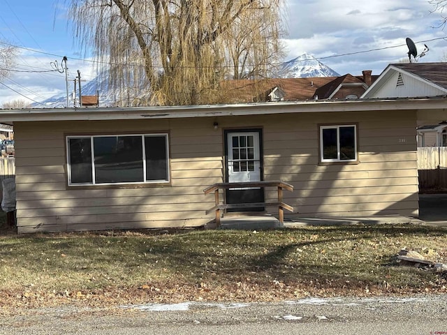 rear view of house with a yard