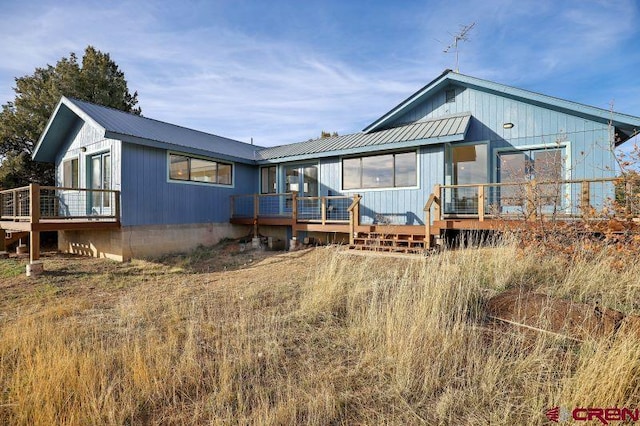 back of house featuring a wooden deck