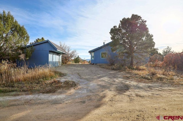 view of property exterior with an outdoor structure