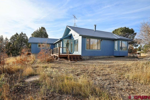 back of property featuring a deck