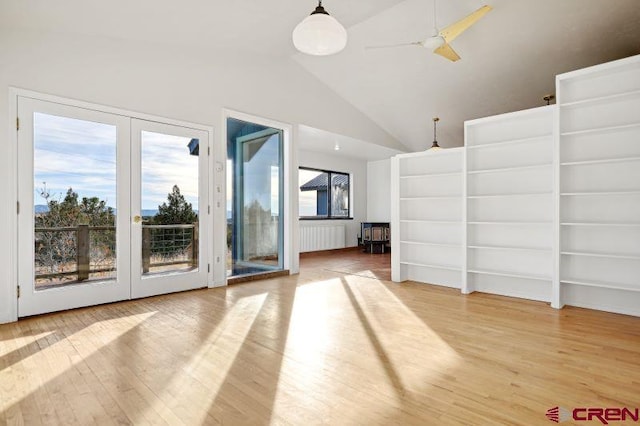 unfurnished living room with french doors, ceiling fan, hardwood / wood-style floors, and lofted ceiling