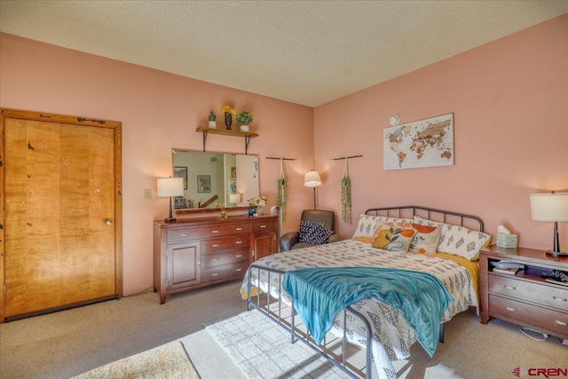 carpeted bedroom with a textured ceiling