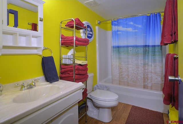 full bathroom with shower / bath combination with curtain, vanity, hardwood / wood-style flooring, and toilet