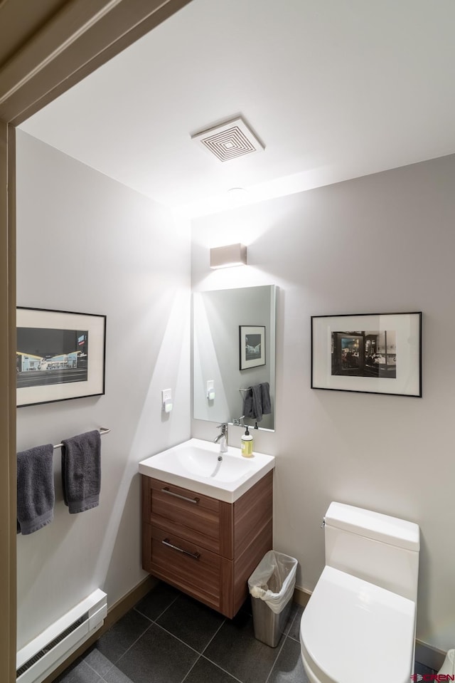 bathroom with baseboard heating, tile patterned flooring, vanity, and toilet