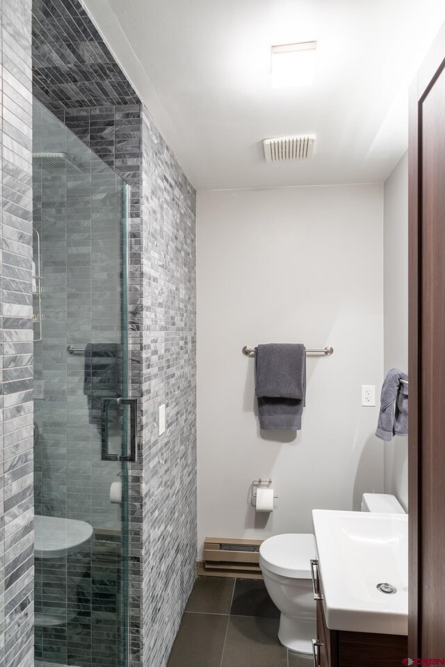 bathroom with tile patterned floors, walk in shower, vanity, a baseboard radiator, and toilet