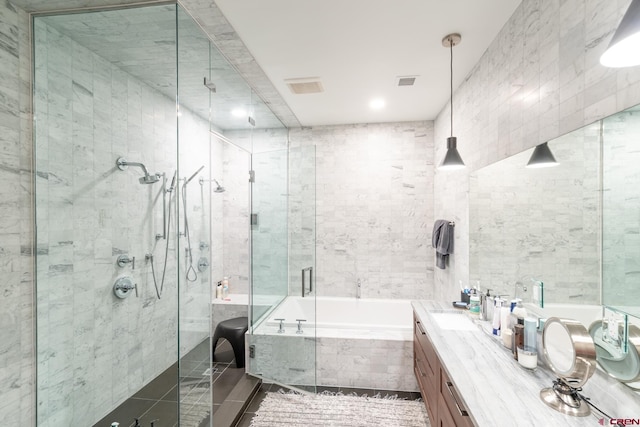 bathroom with vanity, tile walls, and independent shower and bath