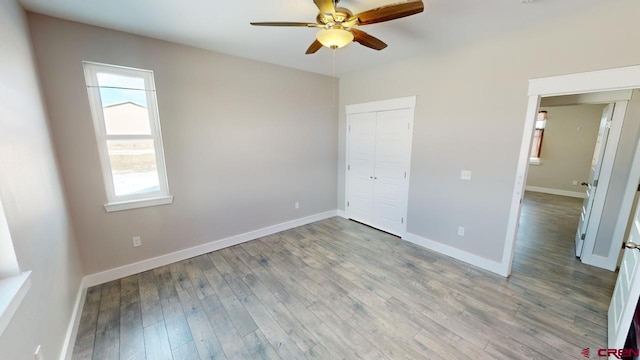 unfurnished bedroom with ceiling fan, a closet, and light hardwood / wood-style floors