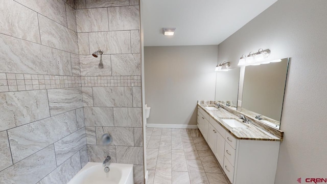 full bathroom with vanity, toilet, and tiled shower / bath