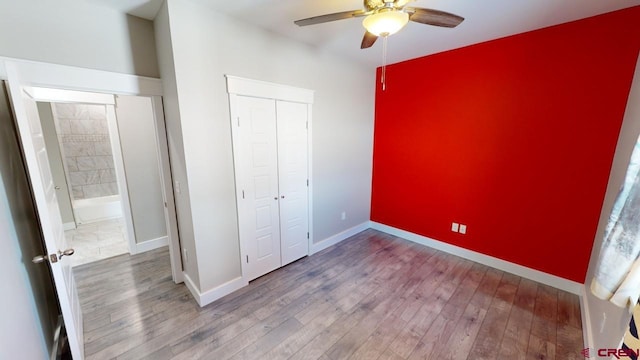 unfurnished bedroom with hardwood / wood-style floors, ceiling fan, and a closet