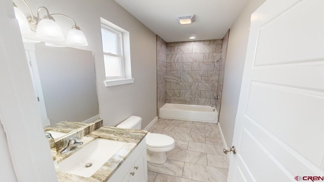 full bathroom with vanity, toilet, and tiled shower / bath