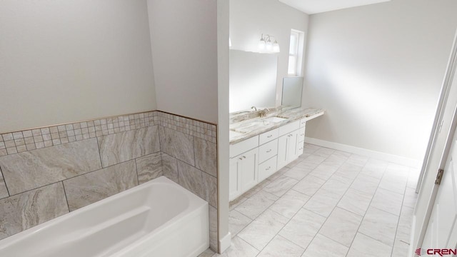 bathroom featuring vanity and a washtub