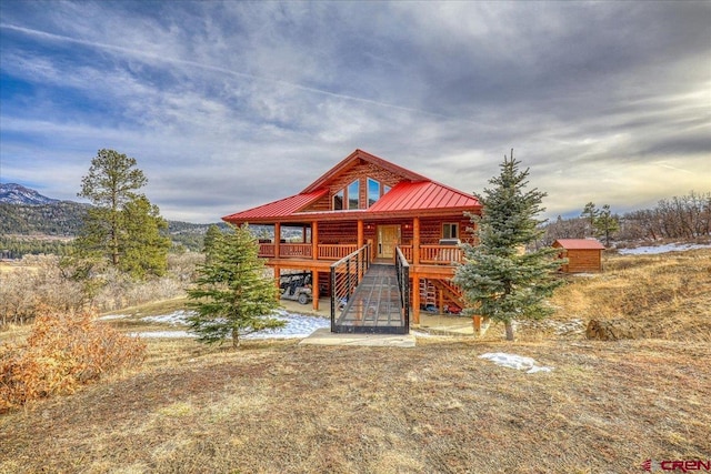 log home featuring a deck with mountain view