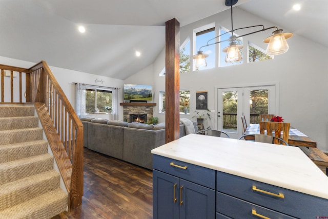 kitchen featuring dark hardwood / wood-style flooring, high vaulted ceiling, plenty of natural light, and blue cabinets