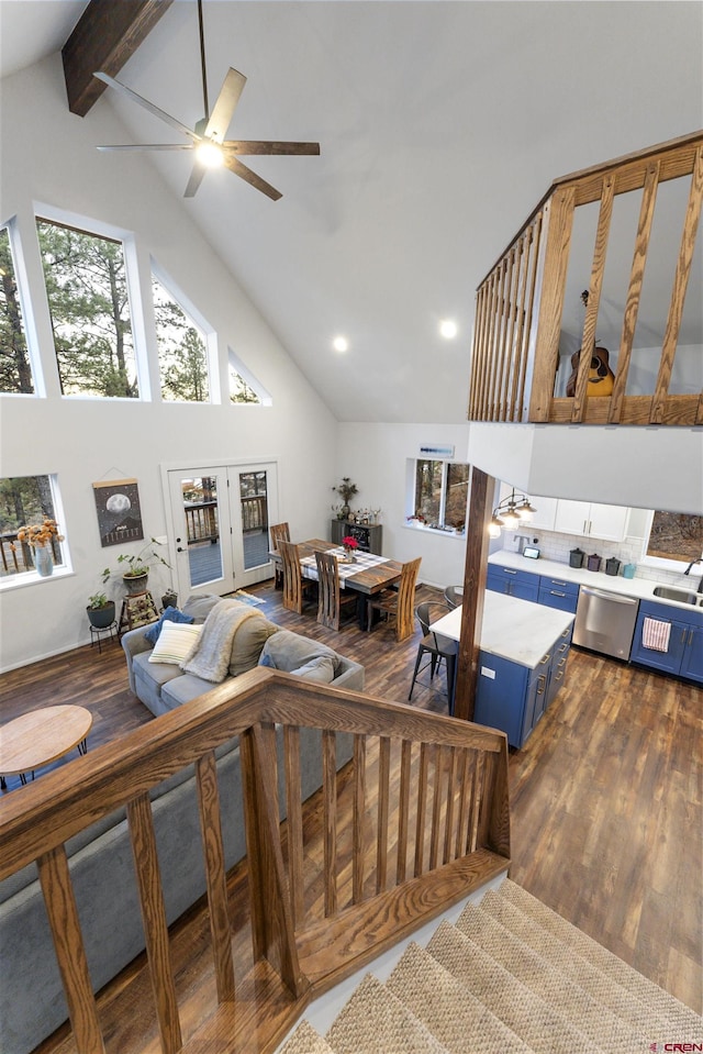 living room featuring french doors, dark hardwood / wood-style flooring, ceiling fan, beam ceiling, and high vaulted ceiling