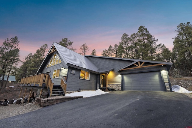 view of front of property featuring a garage and a wooden deck