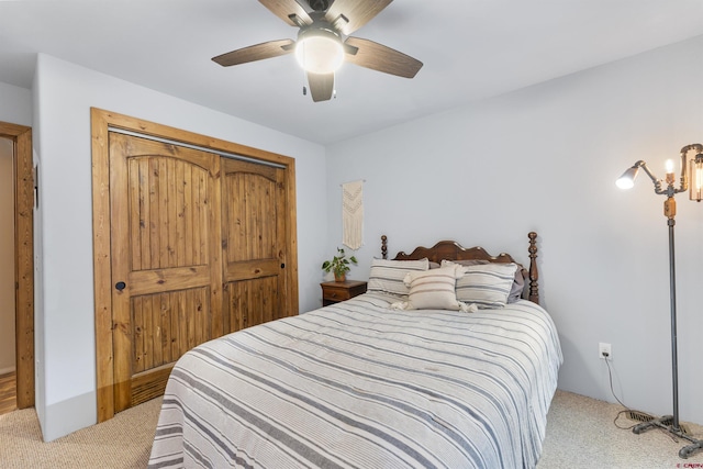 carpeted bedroom featuring a closet and ceiling fan