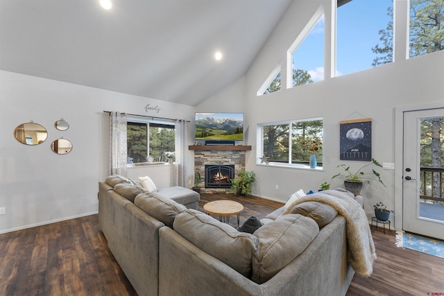 living room featuring plenty of natural light, dark wood-type flooring, and high vaulted ceiling