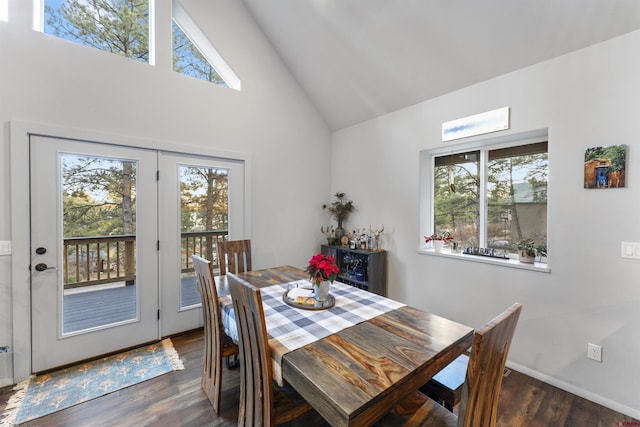 dining space featuring high vaulted ceiling and dark wood-type flooring