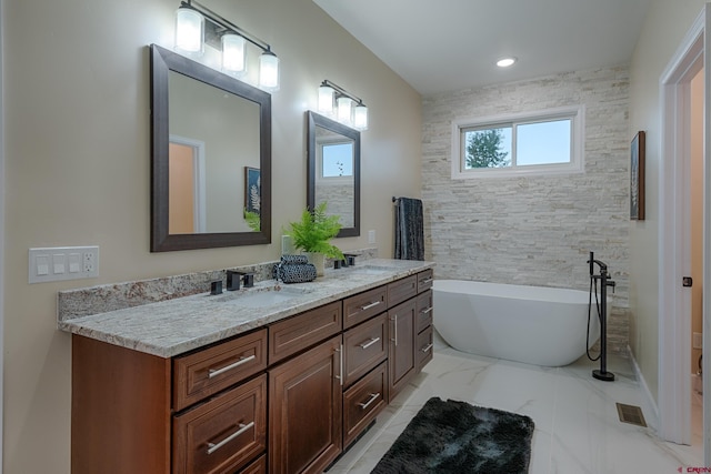 bathroom with vanity and a bathing tub