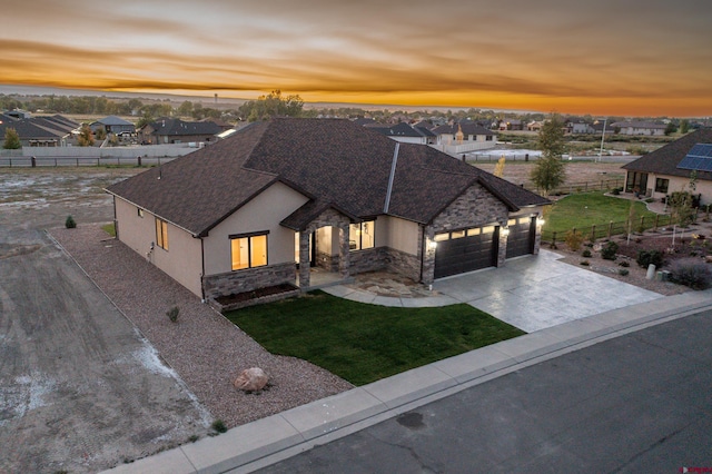 view of front of house featuring a lawn and a garage