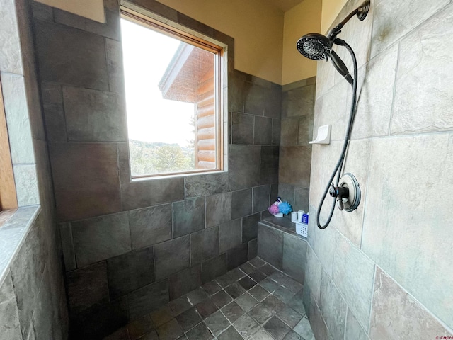 bathroom with a tile shower