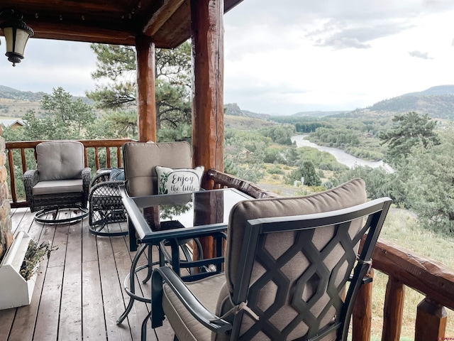 wooden deck with a mountain view