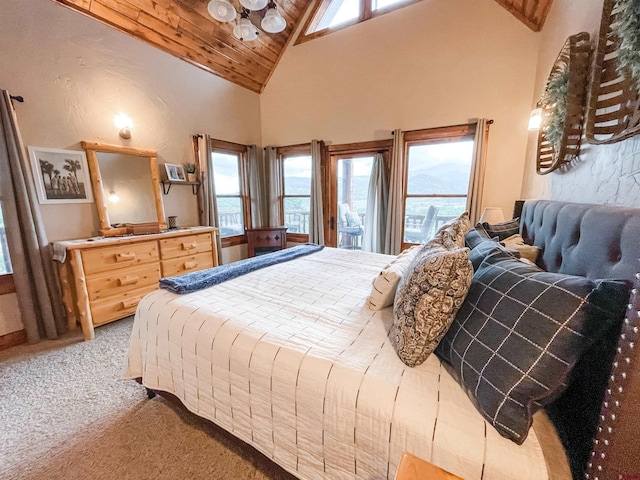 carpeted bedroom with high vaulted ceiling and multiple windows