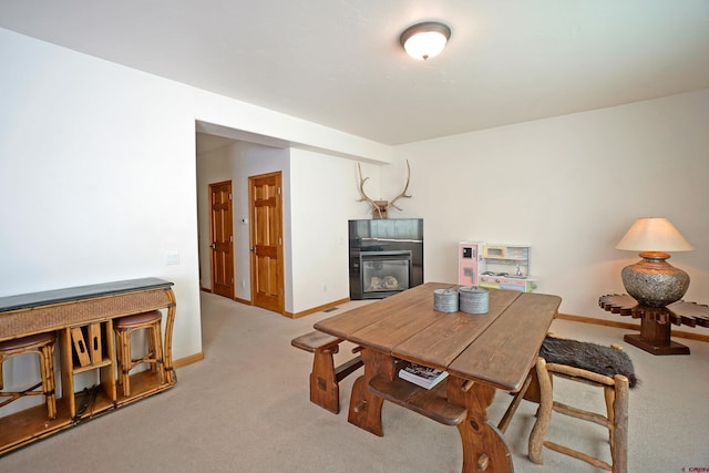 carpeted dining area featuring a fireplace