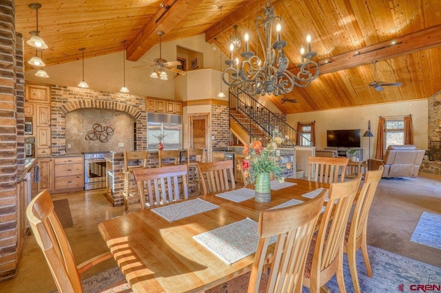 carpeted dining area featuring beam ceiling, ceiling fan with notable chandelier, high vaulted ceiling, and wooden ceiling