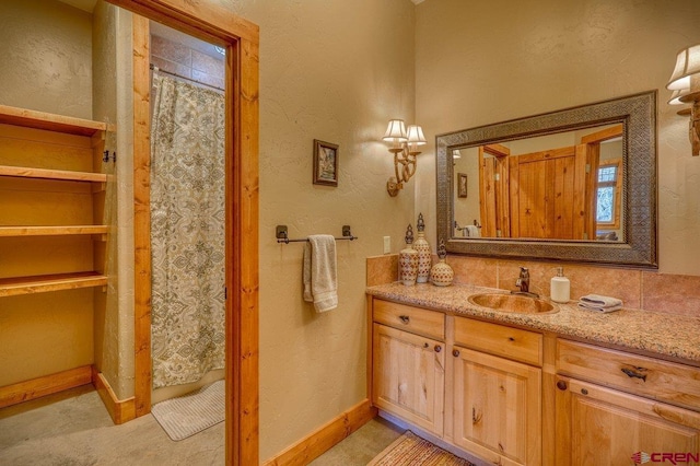 bathroom featuring a shower with shower curtain, vanity, and plenty of natural light