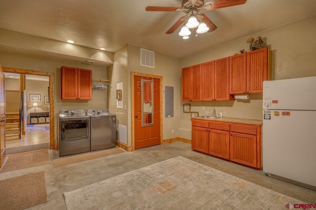 kitchen with electric panel, sink, ceiling fan, washing machine and dryer, and white fridge