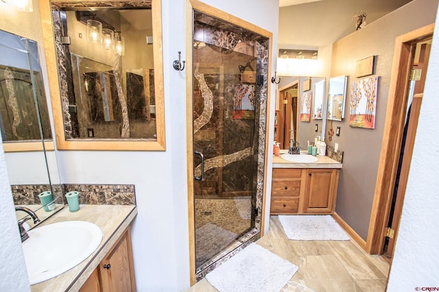 bathroom with vanity and a shower with shower door