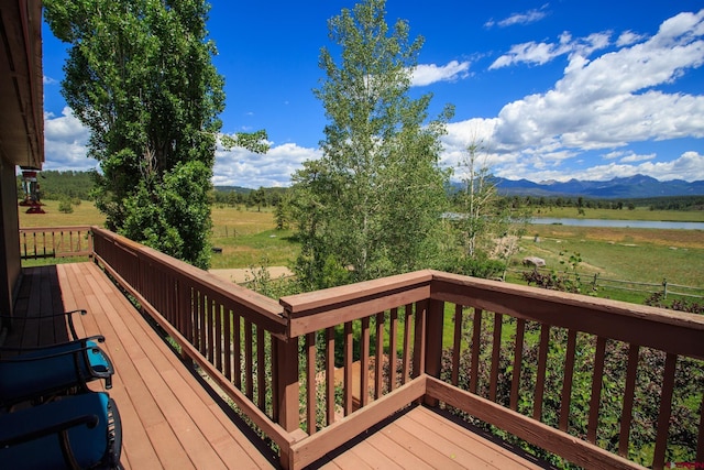 deck with a water and mountain view