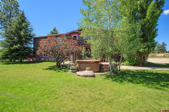 view of yard featuring a wooden deck and a hot tub