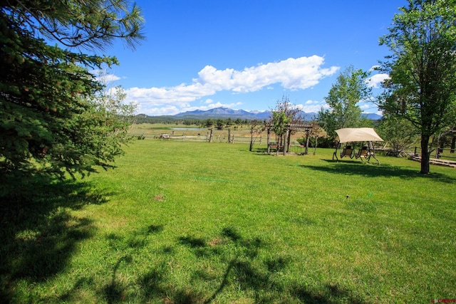 view of yard featuring a mountain view and a rural view