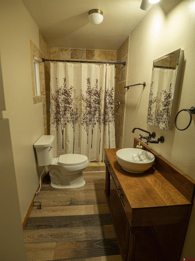 bathroom featuring toilet, hardwood / wood-style floors, vanity, and a shower with shower curtain