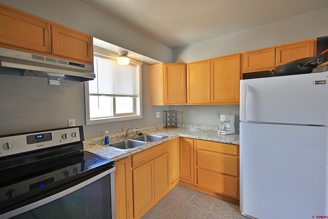 kitchen featuring stainless steel electric stove, light stone counters, sink, and white refrigerator