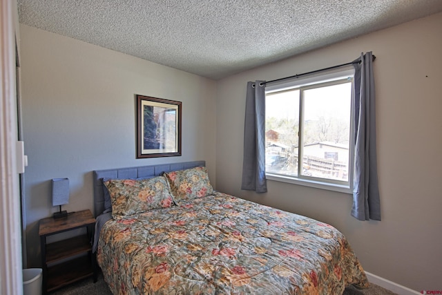 carpeted bedroom with a textured ceiling