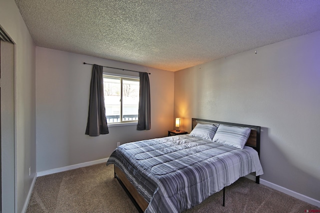 bedroom featuring carpet and a textured ceiling